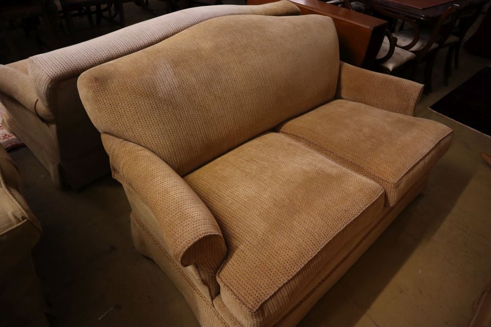A pair of contemporary beige upholstered two seater settees, width 180cm depth 106cm max height 80cm